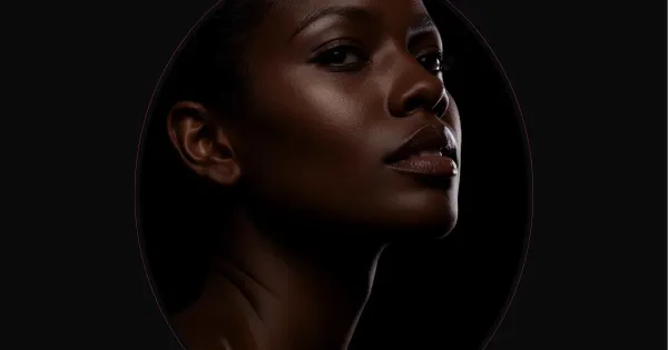 Woman applying serum for glowing skin.