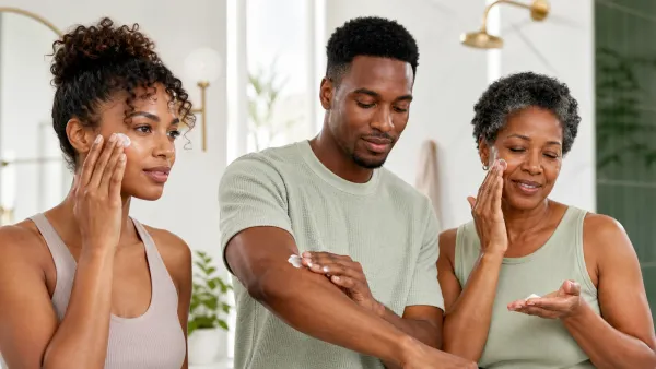 Adults with darker skin tones applying moisturizer to face and arm